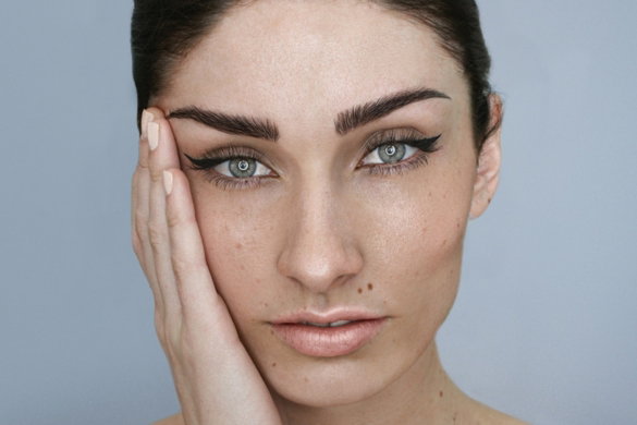 a woman with her hand on her face